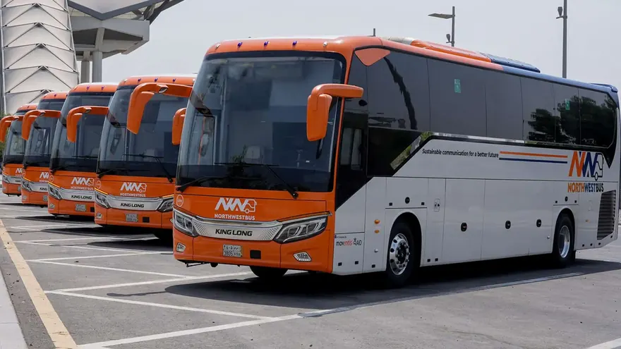 Northwest Bus branded fleet parked at the station